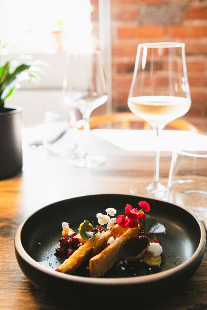 A dish from TERRA's fall menu on a set table by the window